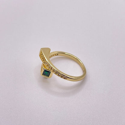 Cross paths gold ring - Emerald laying flat