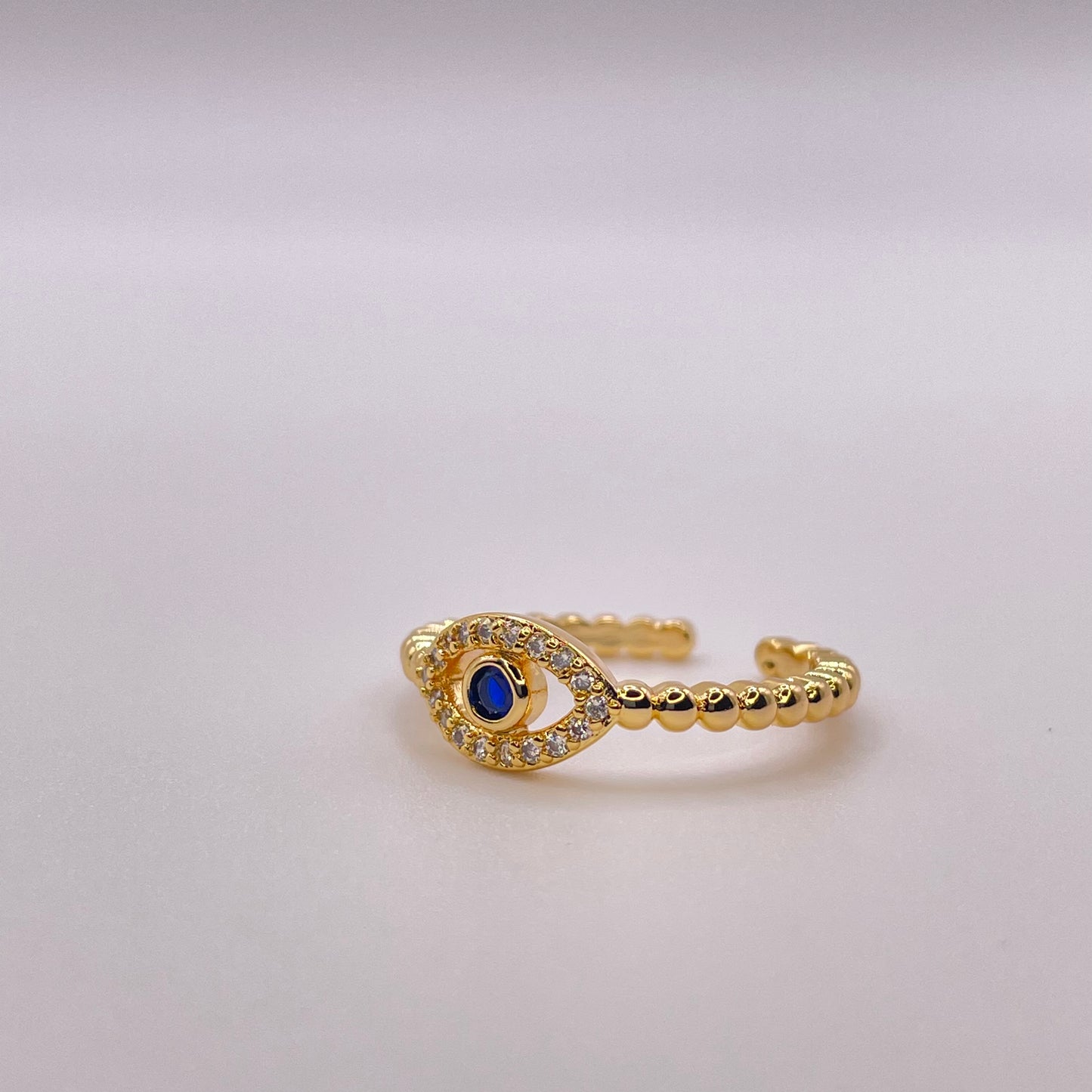 Blue zircon evil eye - Gold front view