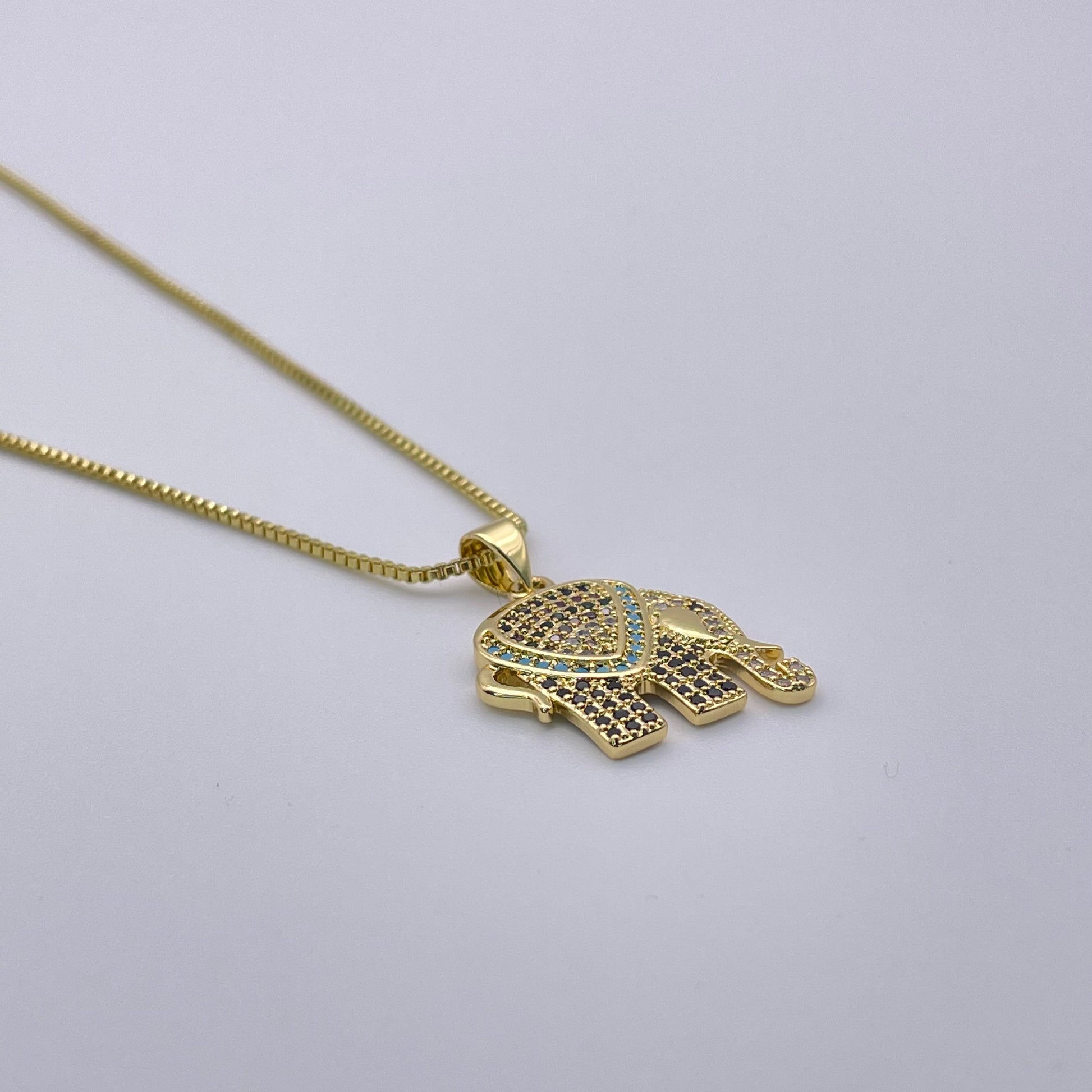 Golden elephant necklace flat view